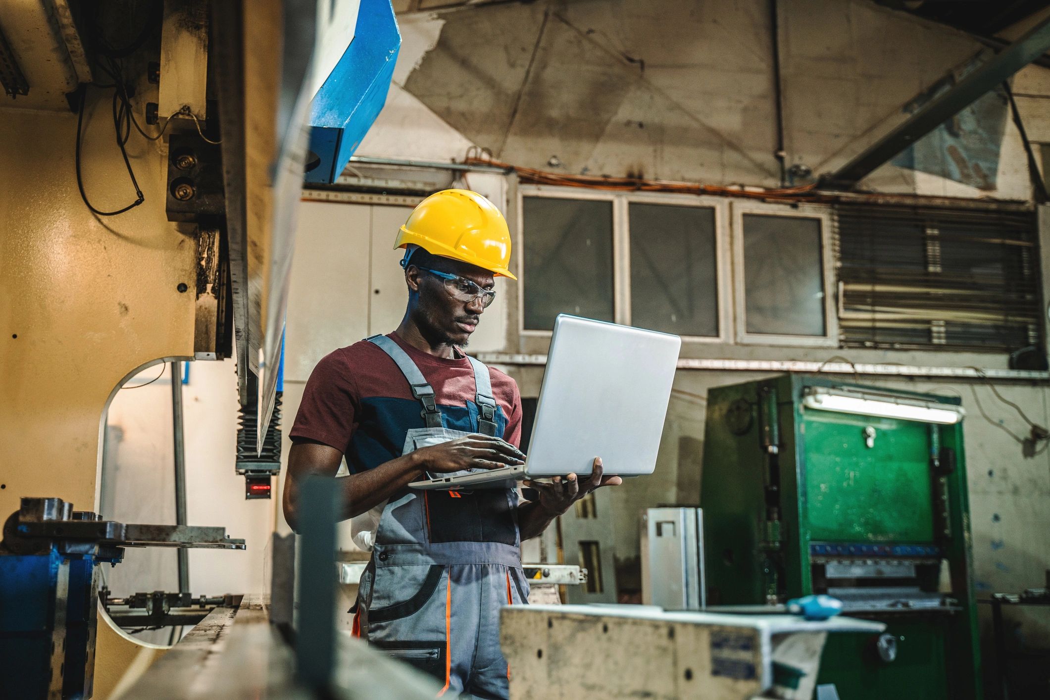 Technician using a laptop in a factory environment