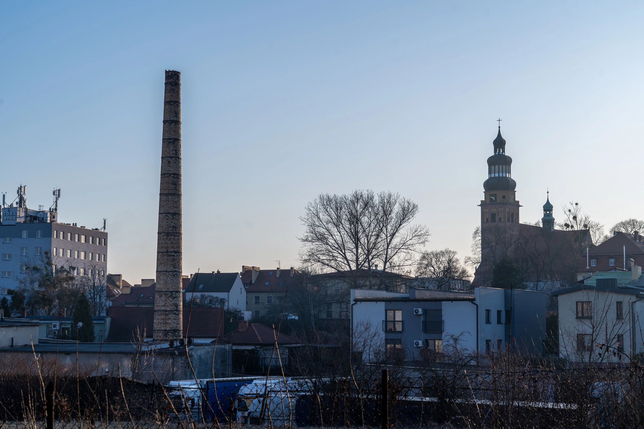 Industrial chimney and plant skyline representing heating infrastructure